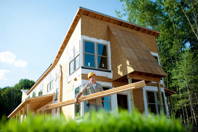 General contractor carrying wooden planks for construction.