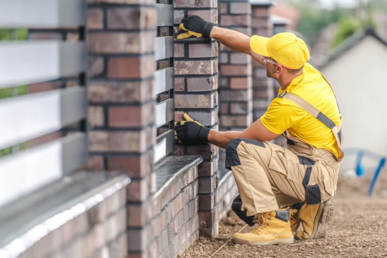 General contractor finishing a stone fence.