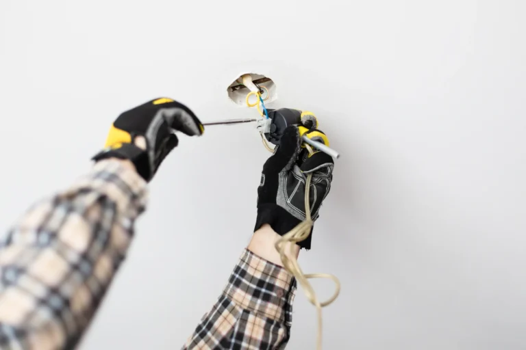 Electrical technician repairing electrical wiring.