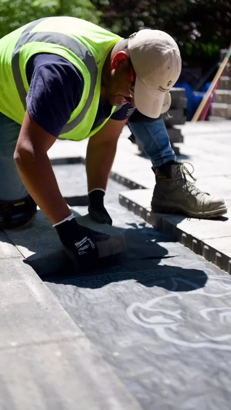 Straight Home Solutions expert laying brick interlocking with precision.