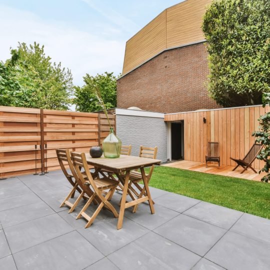 Well-maintained courtyard interlocking surrounded by a wooden fence